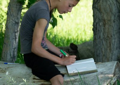 Students at Boulder Valley Waldorf get outside the classroom to work on their main lesson books.